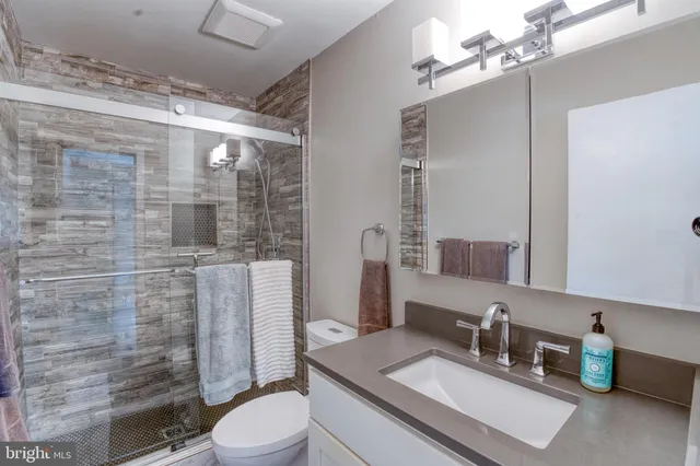 a view of a livingroom with a ceiling fan and window
