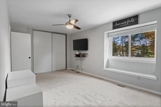 a bathroom with a bathtub shower sink vanity and toilet
