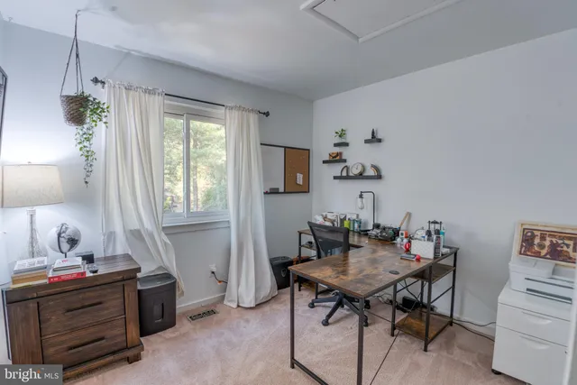 a living room with furniture and stairs