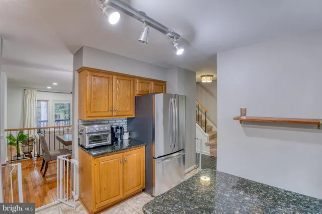 a kitchen with stainless steel appliances granite countertop a stove sink and cabinets