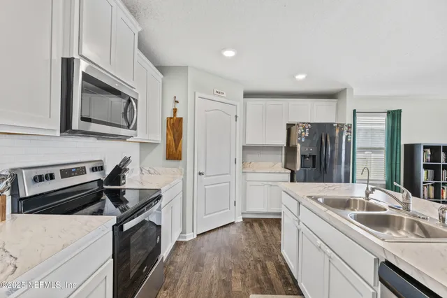 a kitchen with a sink stove and refrigerator