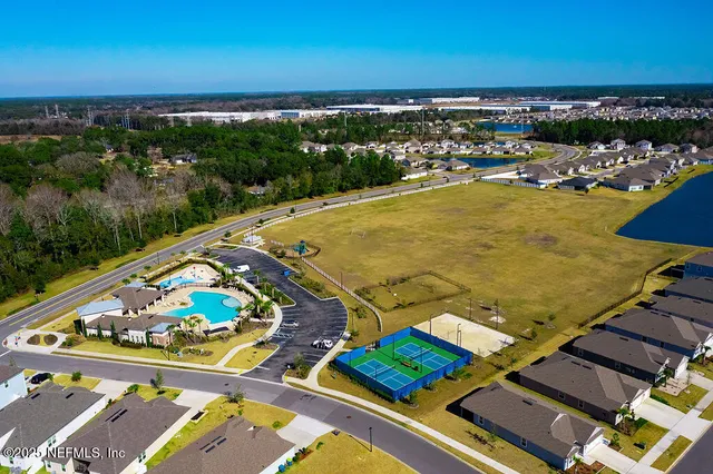 an aerial view of residential houses with outdoor space