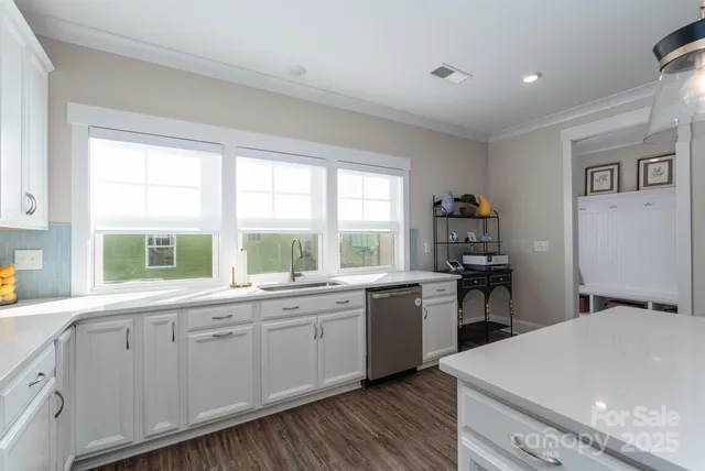 a kitchen with a sink stove and cabinets