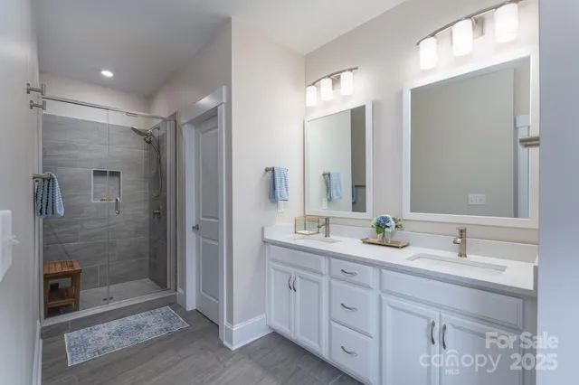 a bathroom with double sink and a mirror