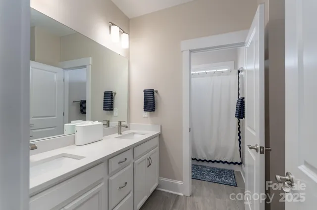 a spacious bathroom with a double vanity sink and a mirror