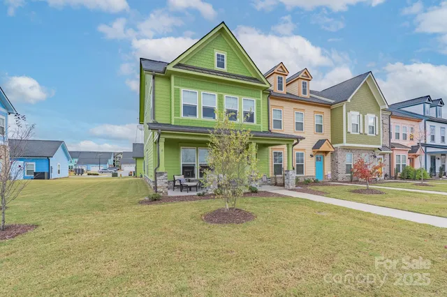 a front view of a house with a garden and plants