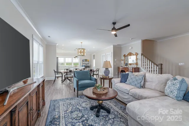 a living room with furniture a rug and a flat screen tv