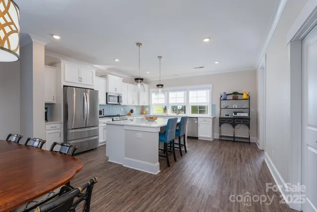 a kitchen with a refrigerator a sink and cabinets