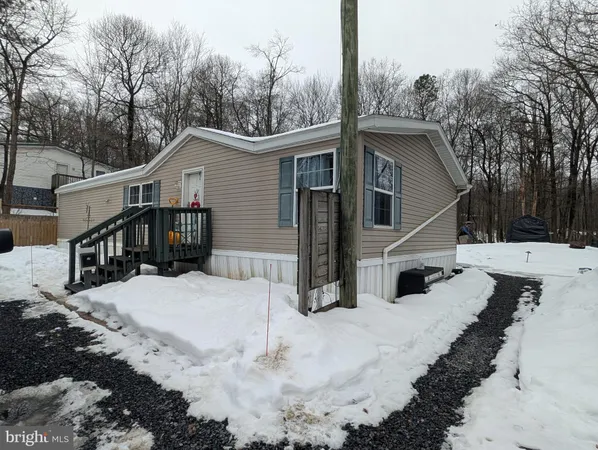a view of a house with a yard covered in snow