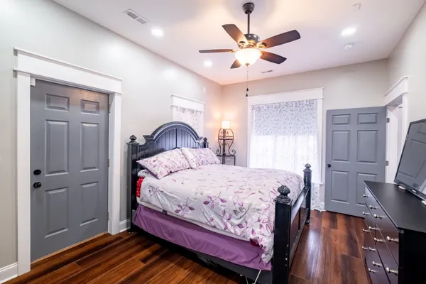 a bedroom with a bed window and a ceiling fan