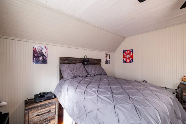 a bedroom with a bed and a desk