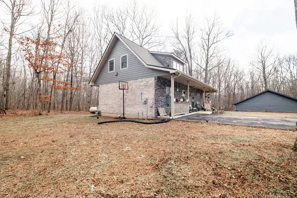 a view of a white house with a yard covered in snow