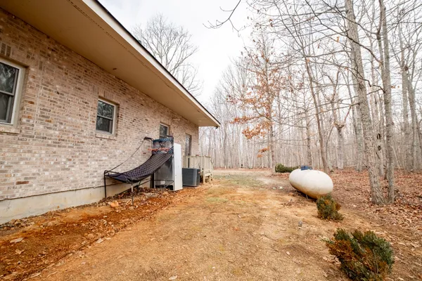 a view of a backyard with a tub and wooden fence
