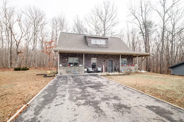a patio with a table and chairs under an umbrella