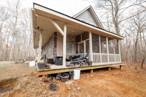 a view of a house with backyard and sitting area
