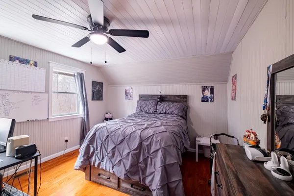 a bed sitting in a bedroom next to a window