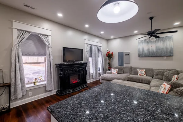 a living room with furniture a flat screen tv and a fireplace
