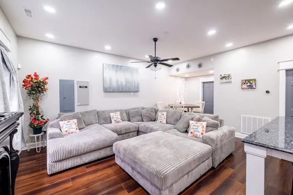 a living room with furniture and flowers