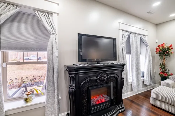 a living room with a fireplace and a flat screen tv