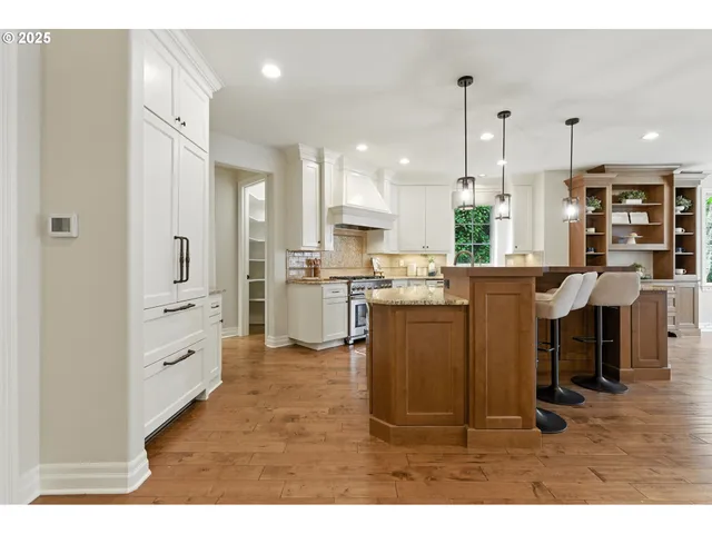 a kitchen with cabinets and chairs