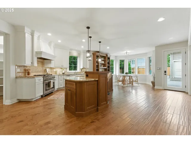 a kitchen with stainless steel appliances kitchen island wooden cabinets and stove