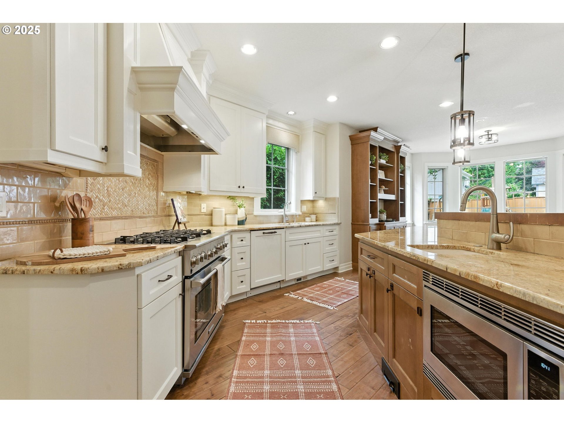784 3rd Street Lake Oswego, OR 97034 - Photo 10 of 48 a kitchen with stainless steel appliances granite countertop a sink a stove top oven a counter space and cabinets
