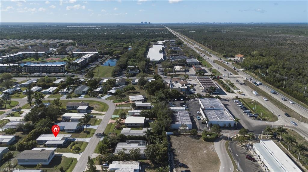140 Rookery Road Naples, FL 34114 - Photo 16 of 19 Aerial view of property and surrounding area featuring a large body of water and nearby suburban area