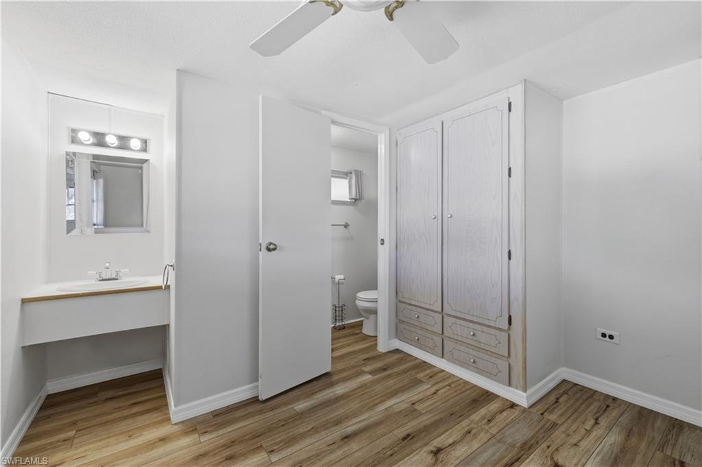 140 Rookery Road Naples, FL 34114 - Photo 17 of 19 Unfurnished bedroom featuring light wood-style floors, ceiling fan, and ensuite bathroom