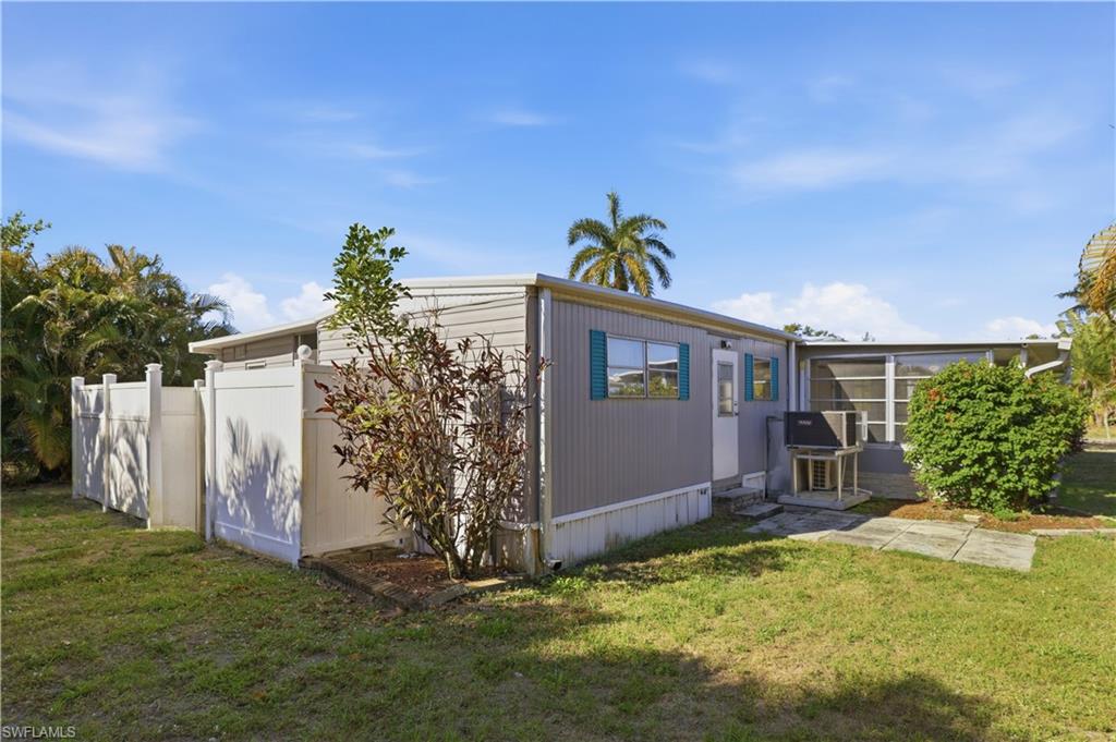140 Rookery Road Naples, FL 34114 - Photo 18 of 19 Back of house featuring a sunroom