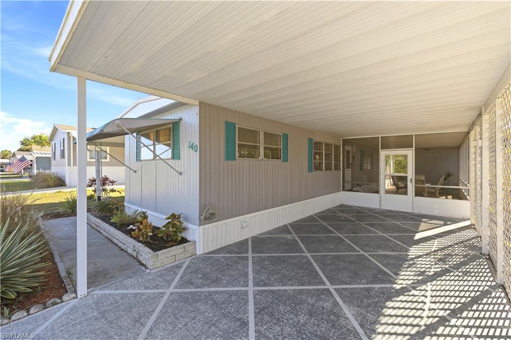 140 Rookery Road Naples, FL 34114 - Photo 3 of 19 View of patio featuring a carport