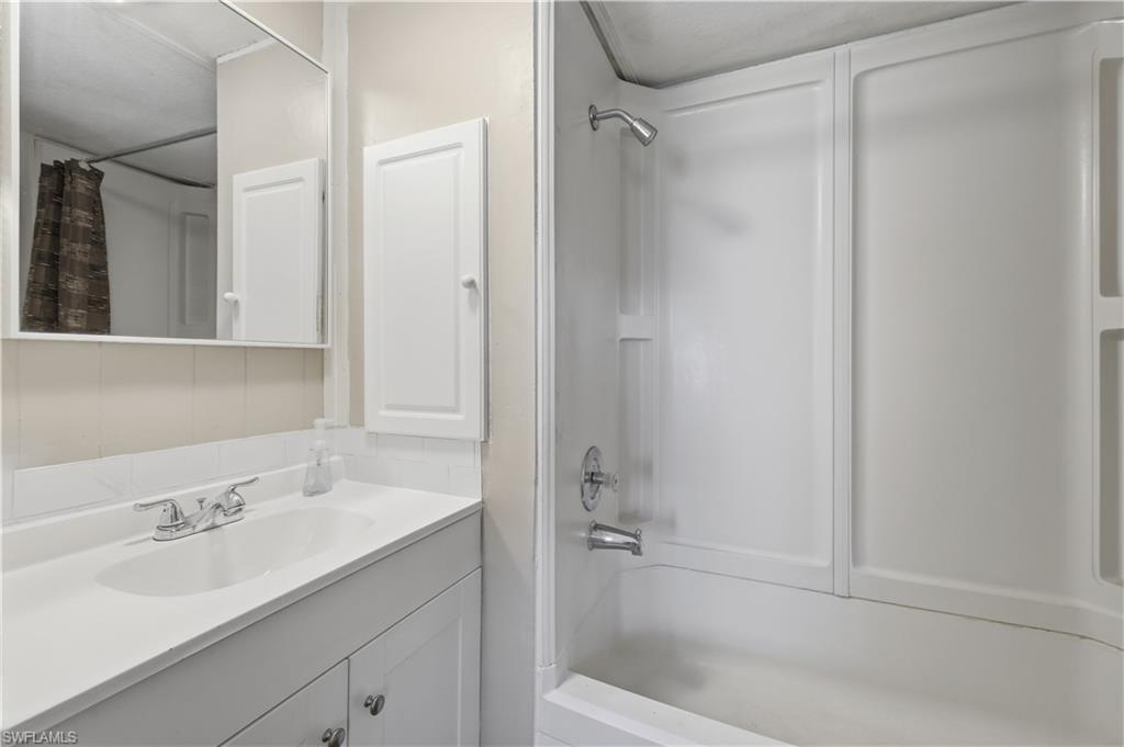 140 Rookery Road Naples, FL 34114 - Photo 6 of 19 Bathroom with vanity and shower / bath combination with curtain