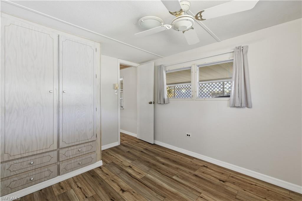 140 Rookery Road Naples, FL 34114 - Photo 7 of 19 Unfurnished bedroom featuring dark wood-style flooring and ceiling fan