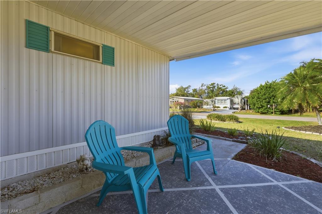 140 Rookery Road Naples, FL 34114 - Photo 10 of 19 Covered porch with a lawn and a residential view