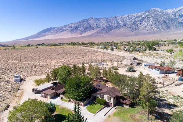 an aerial view of residential house with outdoor space and mountain view