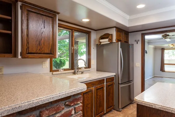 a kitchen with stainless steel appliances granite countertop a refrigerator and a sink