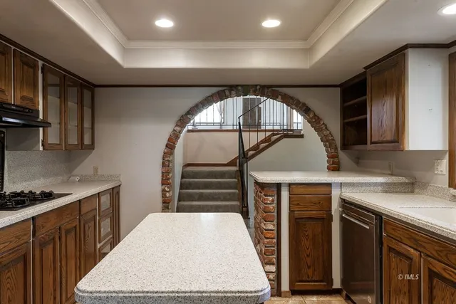 a kitchen with a sink a stove and cabinets