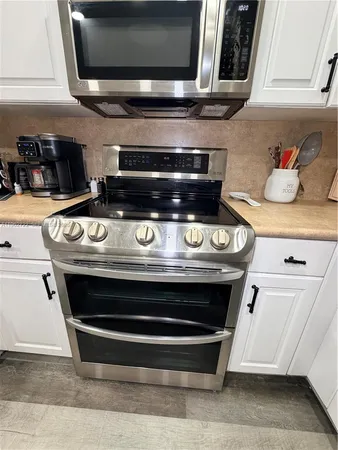 a stove top oven sitting inside of a kitchen
