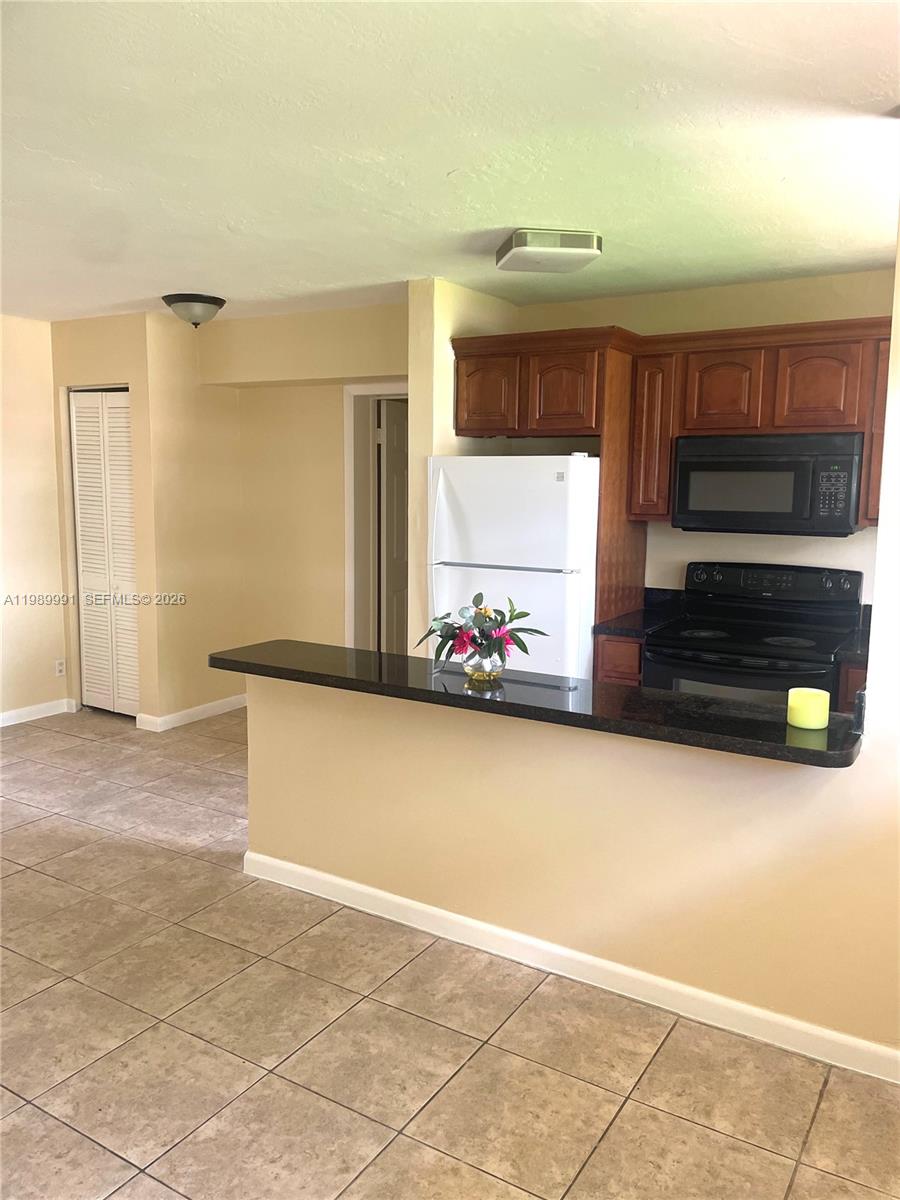 9375 Southwest 40th Terrace, Unit 106 Miami, FL 33165 - Photo 3 of 11 a view of a living room with furniture and a window