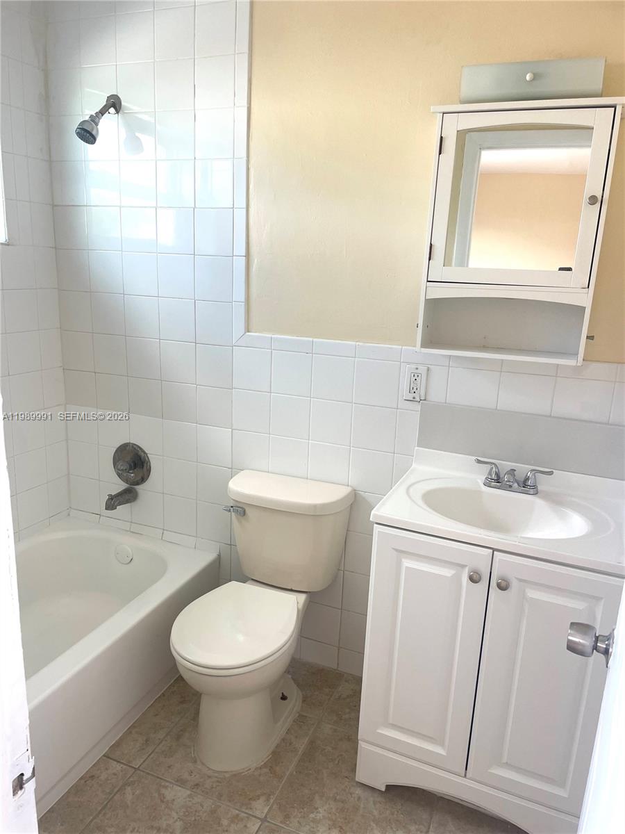 9375 Southwest 40th Terrace, Unit 106 Miami, FL 33165 - Photo 7 of 11 a bathroom with a sink a toilet and shower