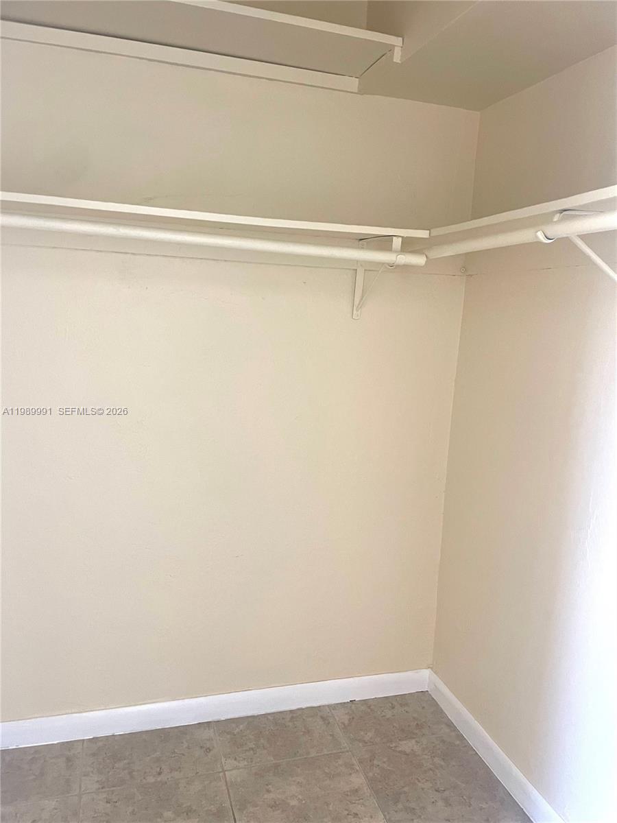 9375 Southwest 40th Terrace, Unit 106 Miami, FL 33165 - Photo 8 of 11 a view of a room with racks on the wall