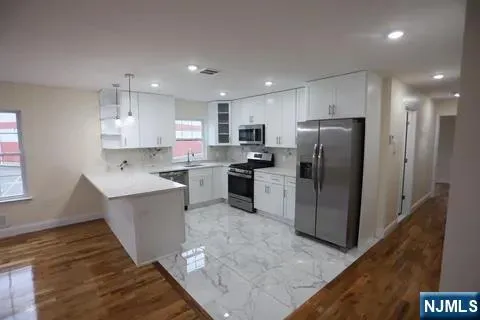 a kitchen with a refrigerator a sink and a microwave