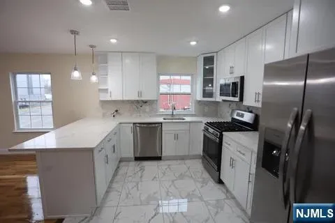a kitchen with a sink stove and refrigerator