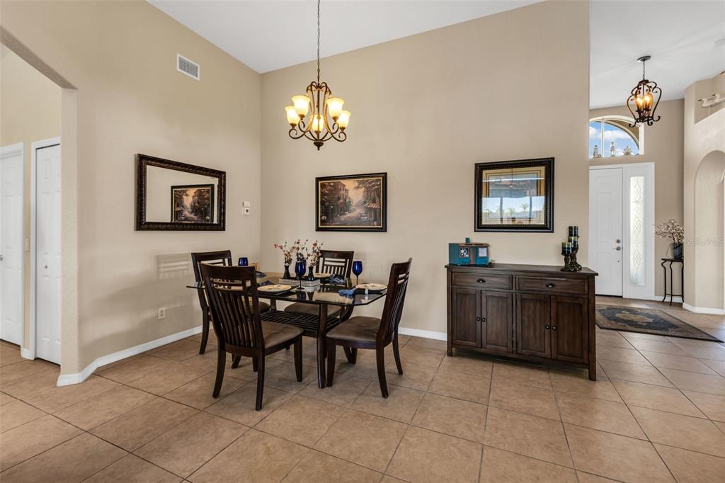 24612 Buckingham Way Punta Gorda, FL 33980 - Photo 12 of 42 a view of a dining room with furniture and chandelier