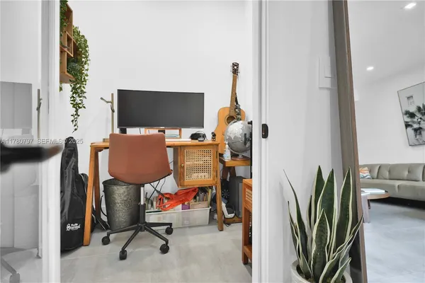 a kitchen with stainless steel appliances kitchen island a table and chairs