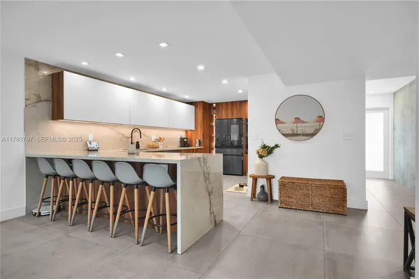 a kitchen with stainless steel appliances a sink and a refrigerator