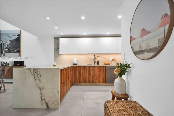 a kitchen with stainless steel appliances a refrigerator and wooden cabinets
