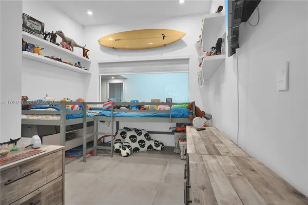 a bedroom with furniture and a window