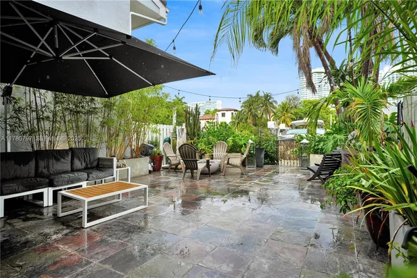 an outdoor space with furniture and umbrella