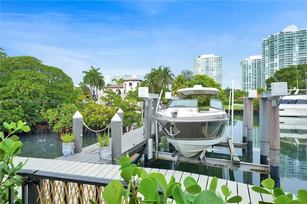 a view of a patio with chairs and potted plants