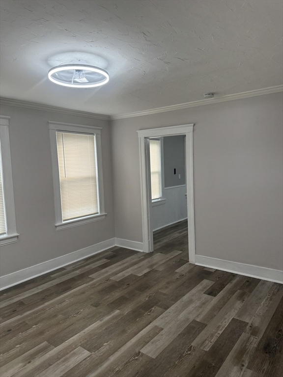 23 Everett Avenue, Unit 1 Webster, MA 01570 - Photo 1 of 9 a view of an empty room with wooden floor and a window